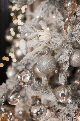 christmas tree decorations in silver white color palette. Silver shiny christmas tree. © Dina