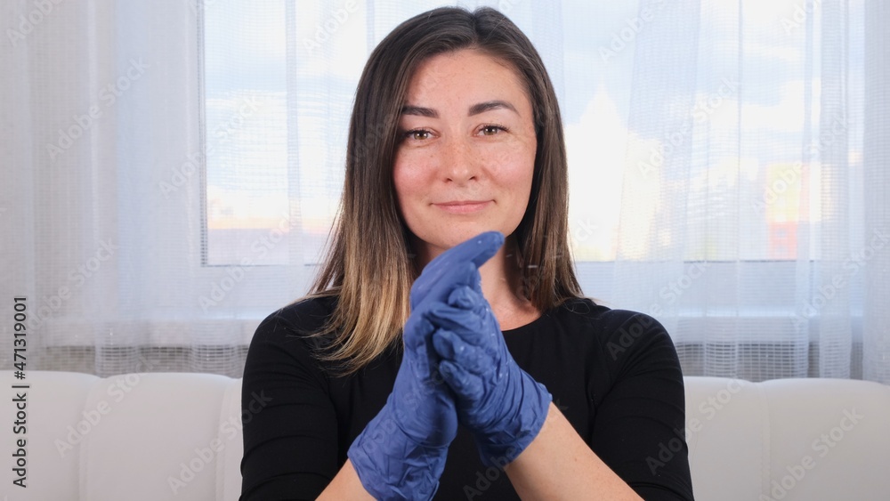 Woman in blue protective gloves using disinfectant hand wash gel to prevent virus epidemic or antibacterial agents. Woman in blue protective gloves using disinfectant hand wash gel to prevent virus epidemic or antibacterial agents.