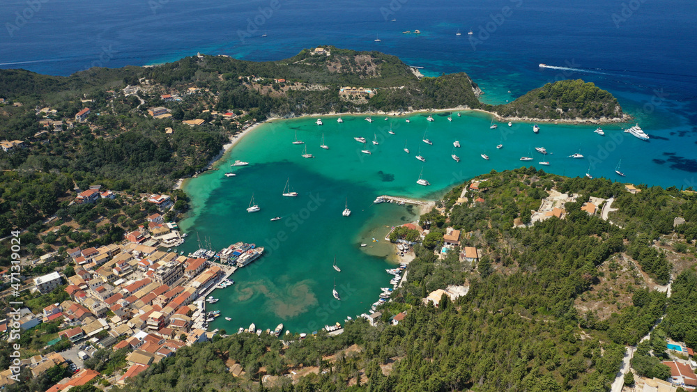 Aerial drone photo of paradise bay and village of Laka visited by yachts and sail boats, island of Paxos, Ionian, Greece