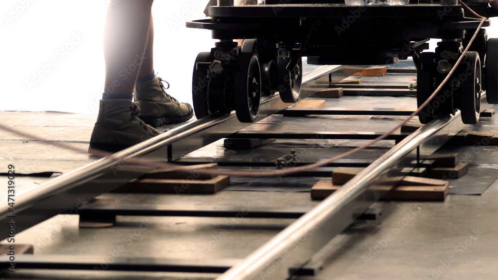 Dolly track for film industry. Behind the scenes of video production team  setting dolly track for video recording camera equipment before movie  shooting in a big studio. Stock Photo | Adobe Stock
