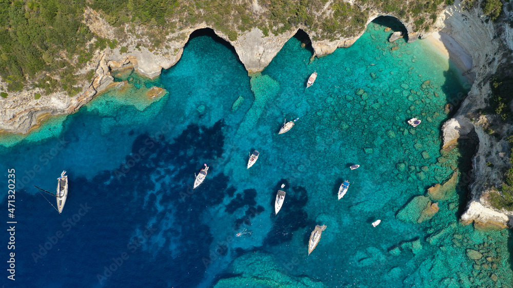 Aerial photo of luxury sail boat anchored in tropical Caribbean rocky turquoise colour seascape