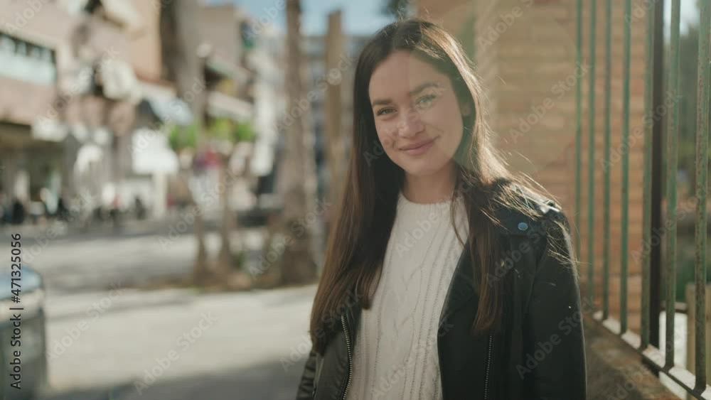 Young hispanic woman smiling confident standing at street Young hispanic woman smiling confident standing at street