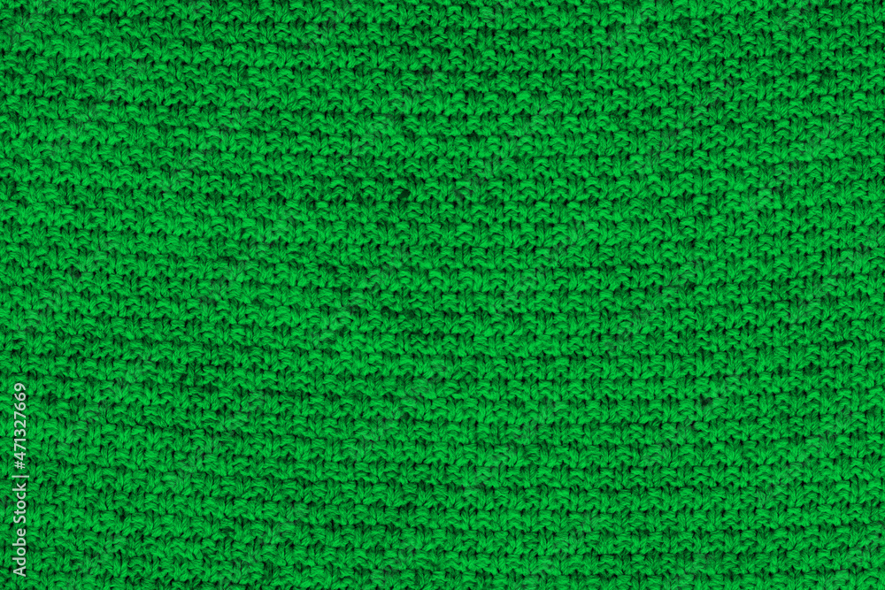 Green knitted fabric texture. Rough sweater background Green knitted fabric texture. Rough sweater background