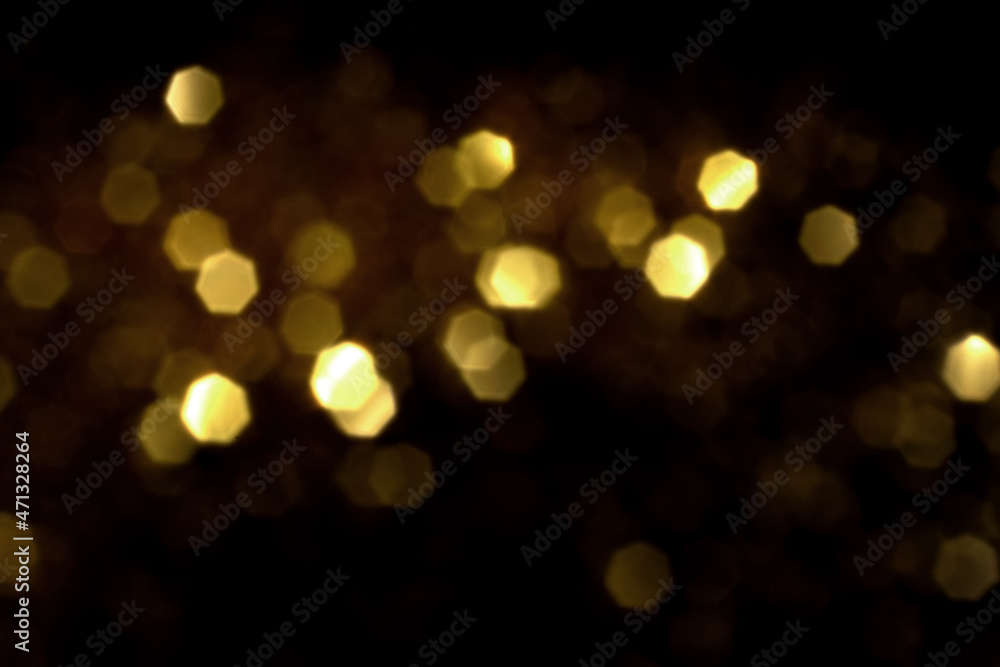 Golden blurred bokeh lights on black background. Glitter sparkle stars for celebrate. Overlay for your design