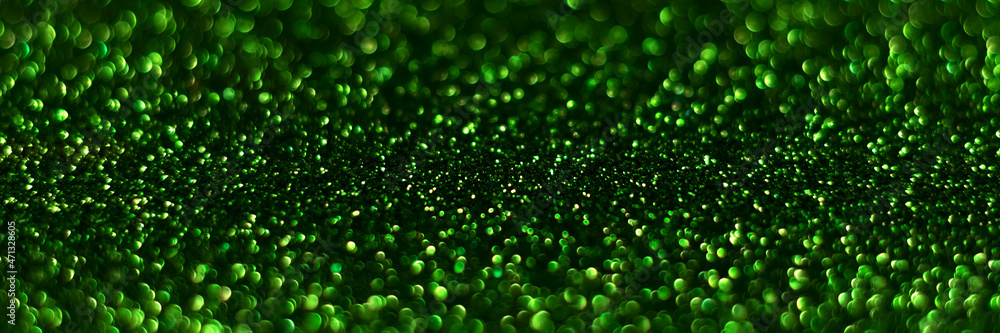 Green sparkling glitter bokeh background, christmas texture. Holiday lights. Abstract defocused header. Wide screen wallpaper. Panoramic web banner with copy space for design Green sparkling glitter bokeh background, christmas texture. Holiday lights. Abstract defocused header. Wide screen wallpaper. Panoramic web banner with copy space for design