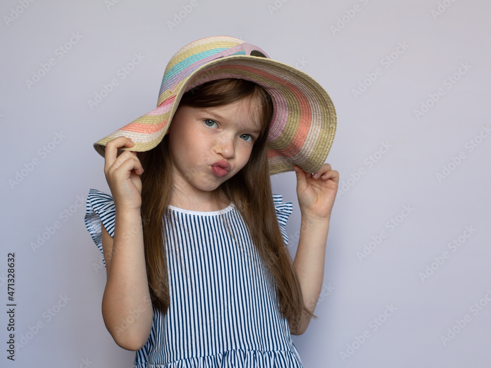 portrait of a cute smiling little girl in a hat