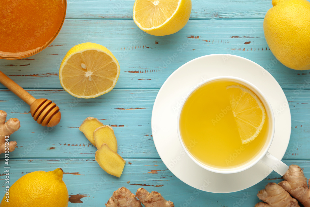 Ginger tea with lemon and honey on blue wooden background. Top view. Ginger tea with lemon and honey on blue wooden background. Top view.