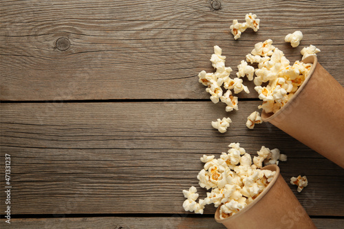 Popcorn in brown cups. Two cups of popcorn on grey wooden background. Sweet popcorn.