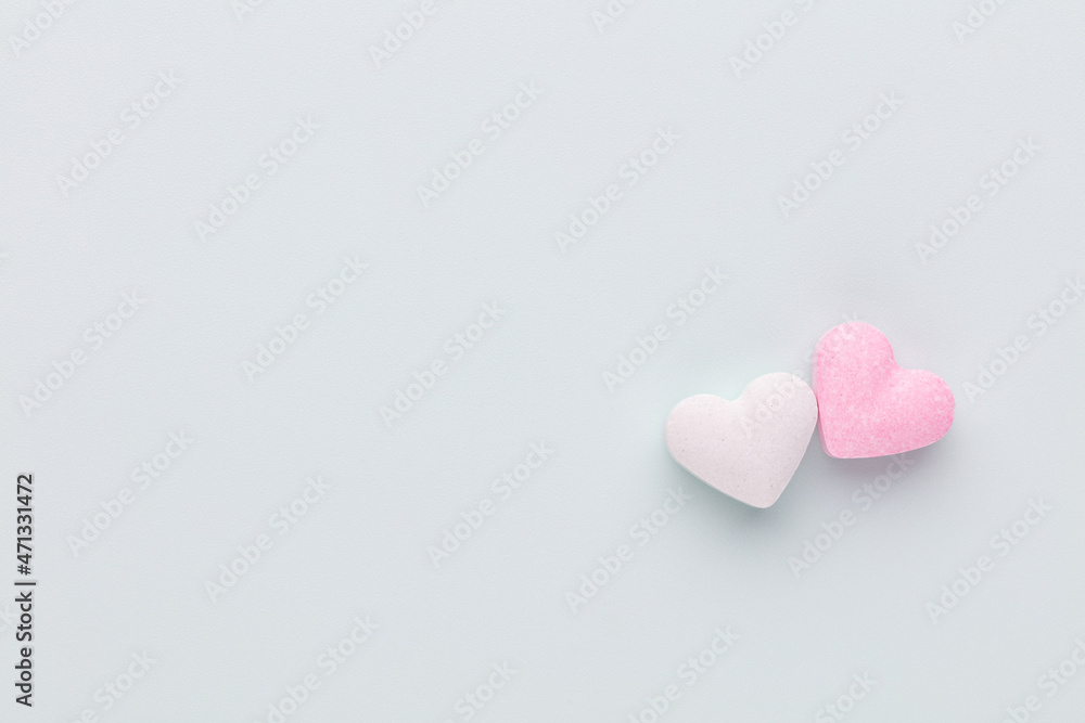 Obraz premium Composition with candy hearts on pastel blue background.