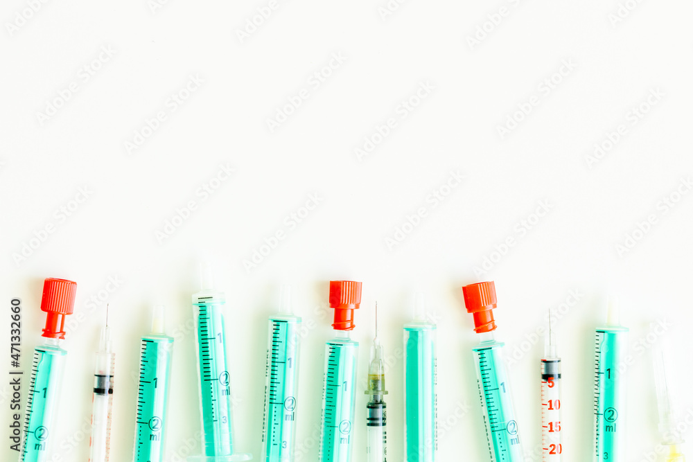 syringes lying on a white background, Place for an inscription, Top view syringes lying on a white background, Place for an inscription, Top view