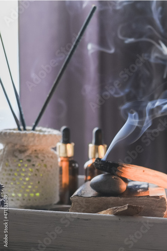 Wellness  health mental.Girl meditates yoga at home with aromatherapy palo santo Care  Wellness   meditation  spa  relax occultism  spiritual cleansing.
