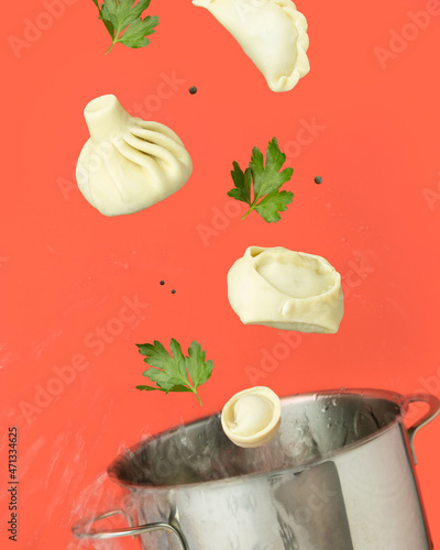 Manty and khinkali fly out of the pan red background