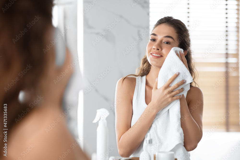 Lady Drying Face With Towel During Morning Routine In Bathroom Lady Drying Face With Towel During Morning Routine In Bathroom
