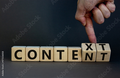 Content and context symbol. Businessman turns wooden cubes and changes the word context to content. Beautiful grey table, grey background. Business and content and context concept. Copy space. photo