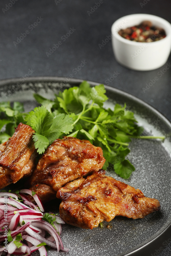 Delicious meat kebab with fresh vegetable. Grilled meat kebabs, vegetables on a dark table. Delicious meat kebab with fresh vegetable. Grilled meat kebabs, vegetables on a dark table.