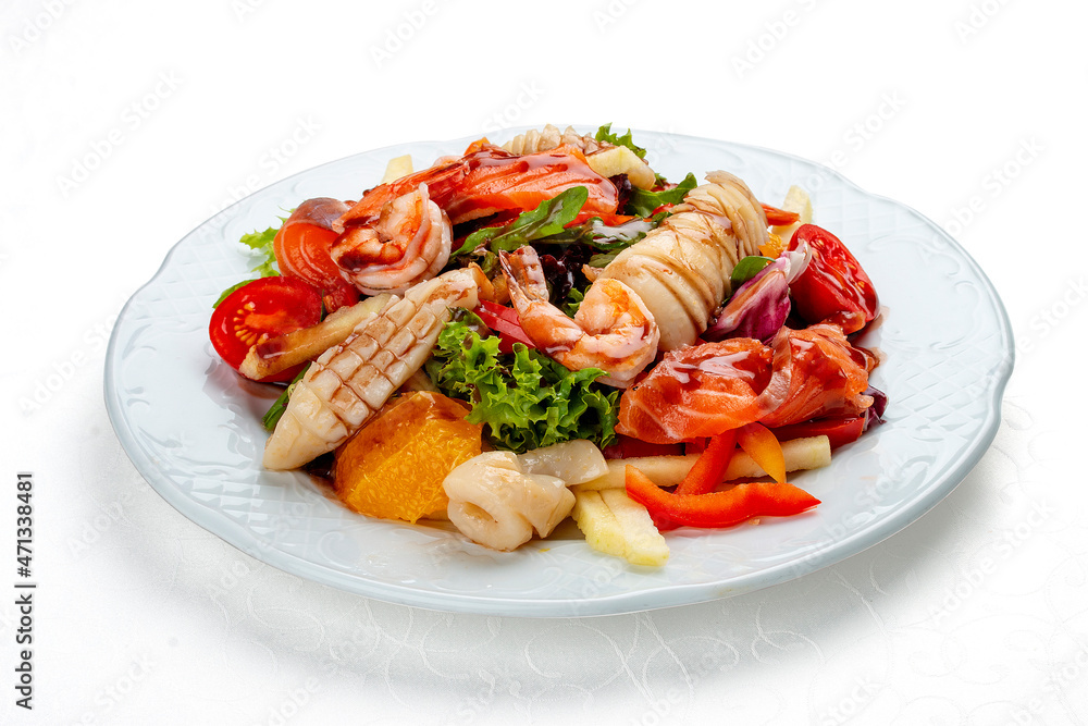 Salad Di Mare .Salad with shrimp, salmon and squid, orange and sweet pepper. Isolated on a white background Salad Di Mare .Salad with shrimp, salmon and squid, orange and sweet pepper. Isolated on a white background