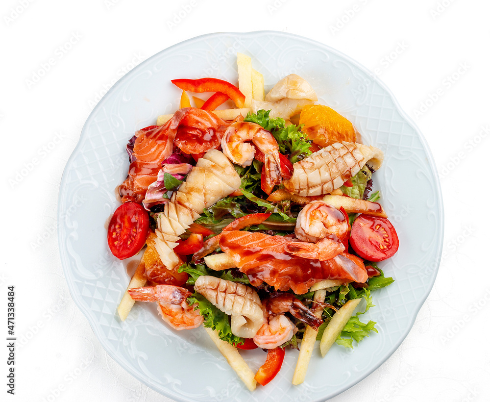 Salad Di Mare. Salad with shrimp, salmon and squid, orange and sweet pepper. Isolated on a white background Salad Di Mare. Salad with shrimp, salmon and squid, orange and sweet pepper. Isolated on a white background