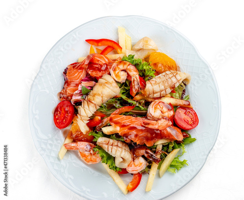 Salad Di Mare. Salad with shrimp, salmon and squid, orange and sweet pepper. Isolated on a white background