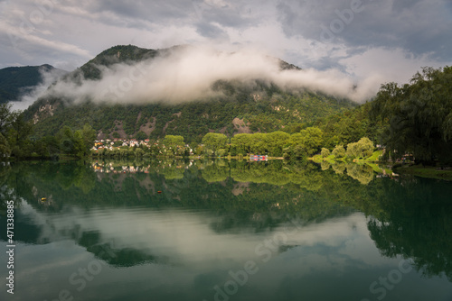 Turquoise water in Soca river and clouds covering mountains in the background, Most Na Soci ,Slovenia © JMDuran Photography