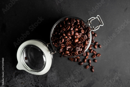 Coffee beans on dark background. Coffee beans in glass jar.
