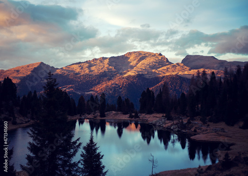 sunset on the lake's shore on dolomites