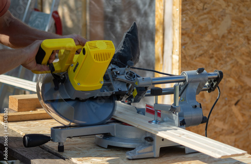 Sawing a board with a miter saw