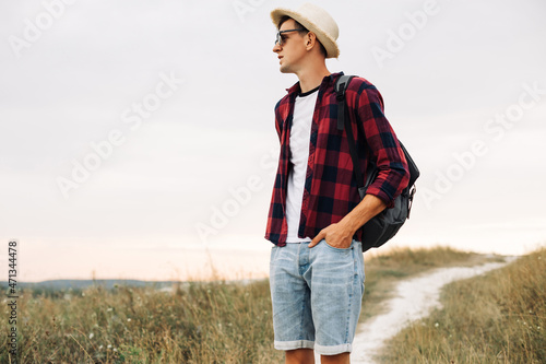 Hiker with a backpack enjoying the view of the valley, the tourist walks along the valley. Travel and adventure concept © Shopping King Louie