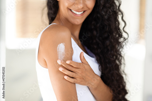 Body Care. Closeup Shot Of Young Woman Applying Moisturizing Lotion On Shoulder