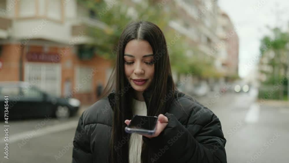Young hispanic woman smiling confident sending audio message at street Young hispanic woman smiling confident sending audio message at street