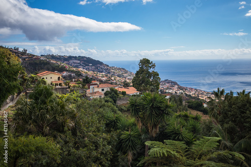 view from the mountain to the European city with green trees by the ocean