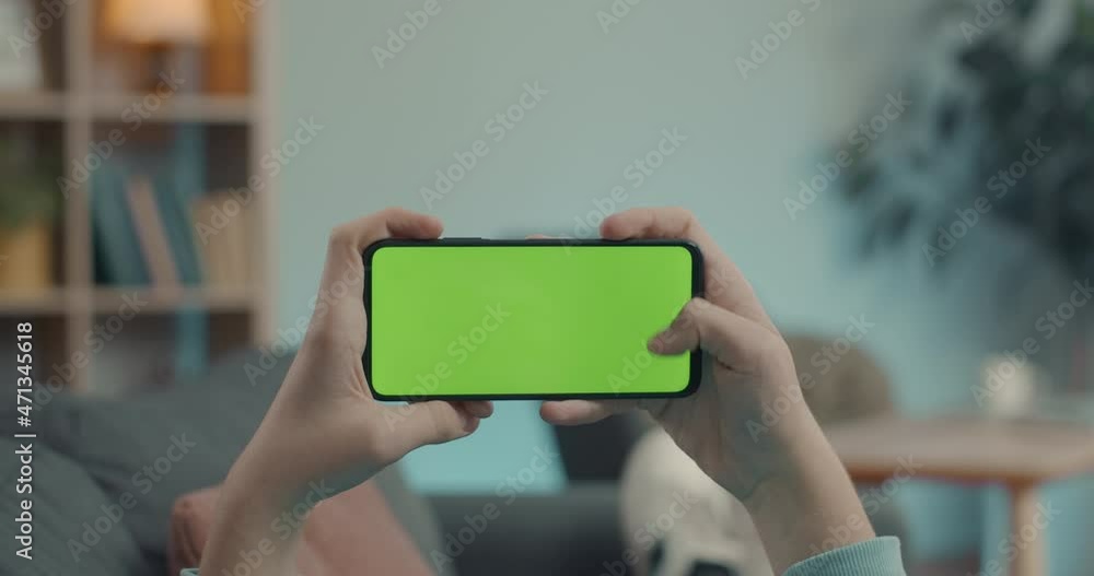 Close up of man sliding on chroma key screen of smartphone Close up of man sliding on chroma key screen of smartphone