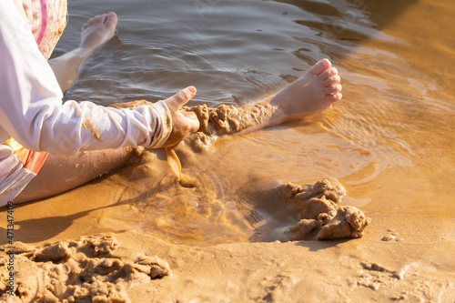 Child playing in the sand of a beach on the Xingu River, northern Brazil.