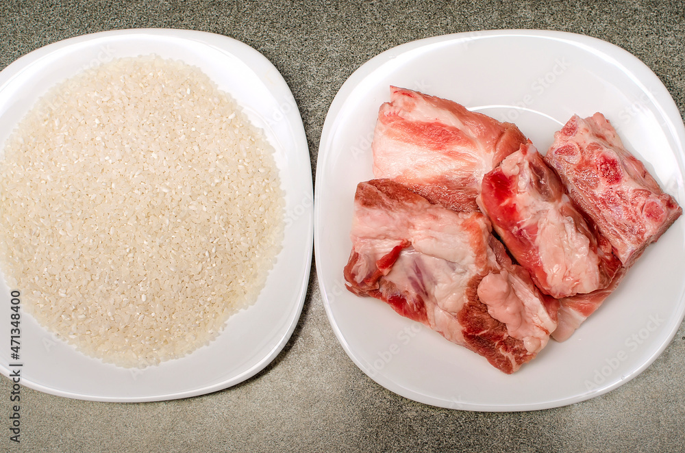 Raw meat and rice grits. Ingridinets for cooking at home.