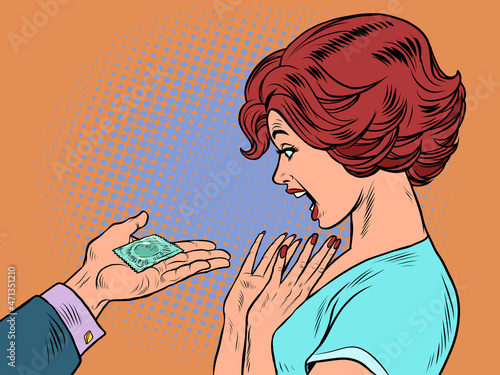 A man gives a woman a condom. Sexual intimacy. Date