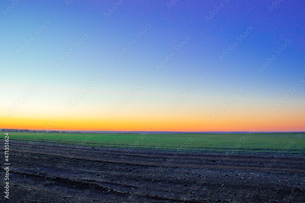 Landscape at freshly sown field, morning sunrise