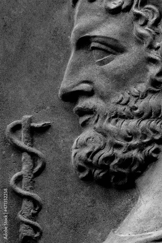 God of treatment Asclepius (Lat. Aesculapius). Fragment of an ancient statue. photo