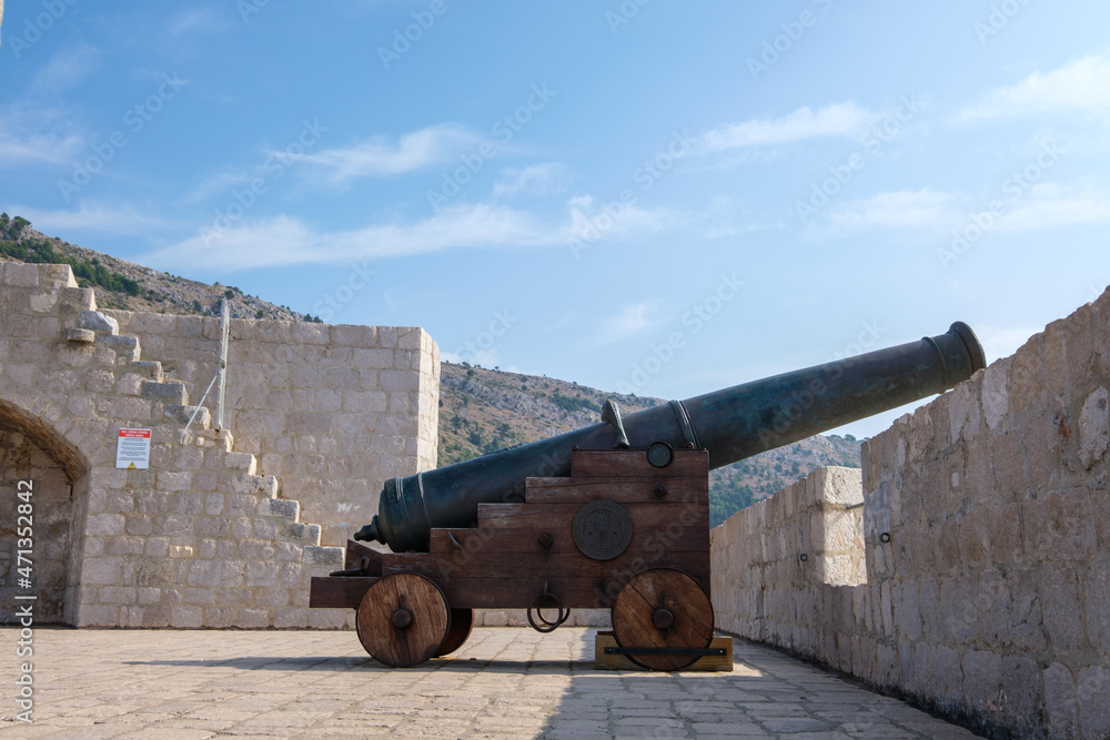 Profile of an old cannon in Dubrovnik. Vintage war weapon for defense and protection. Medieval fort in Dubrovnik protected by guns.