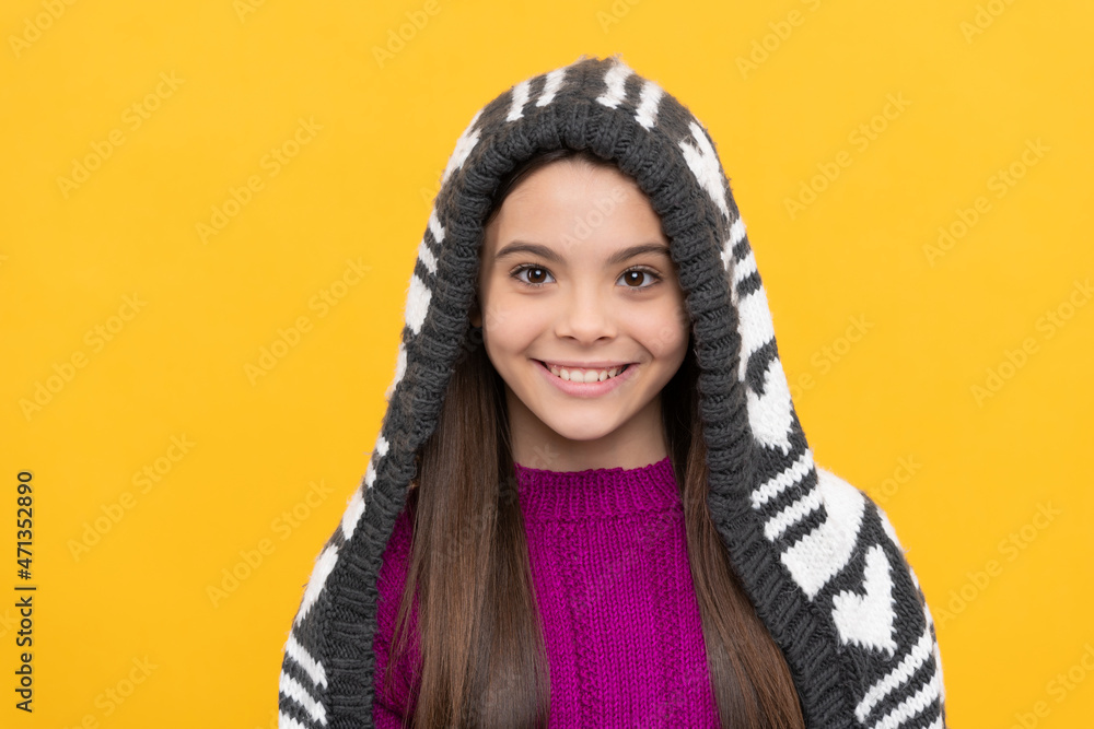 happy kid in earflap hat on yellow background, winter happy kid in earflap hat on yellow background, winter