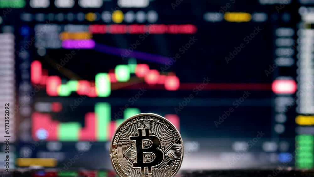 Coin Bitcoin on background cryptocurrency trading chart on computer screen. Digital money, banking, investment, finance and business concept Coin Bitcoin on background cryptocurrency trading chart on computer screen. Digital money, banking, investment, finance and business concept
