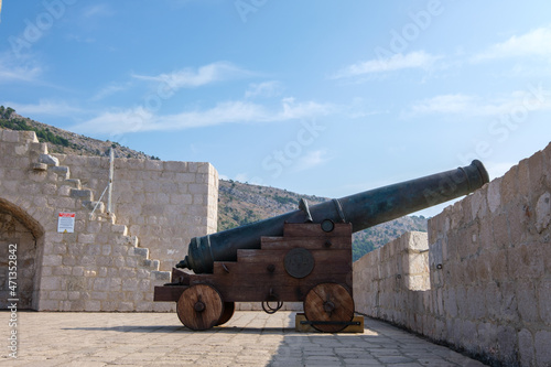 Profile of an old cannon in Dubrovnik. Vintage war weapon for defense and protection. Medieval fort in Dubrovnik protected by guns.