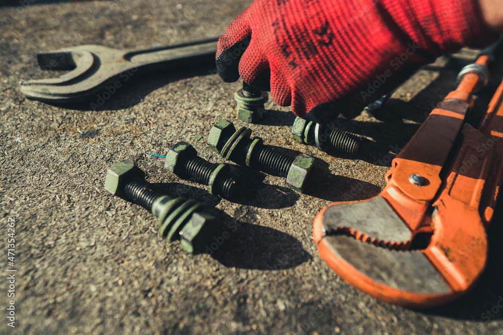 Screws, bolts and fasteners, wrench on an industrial background.