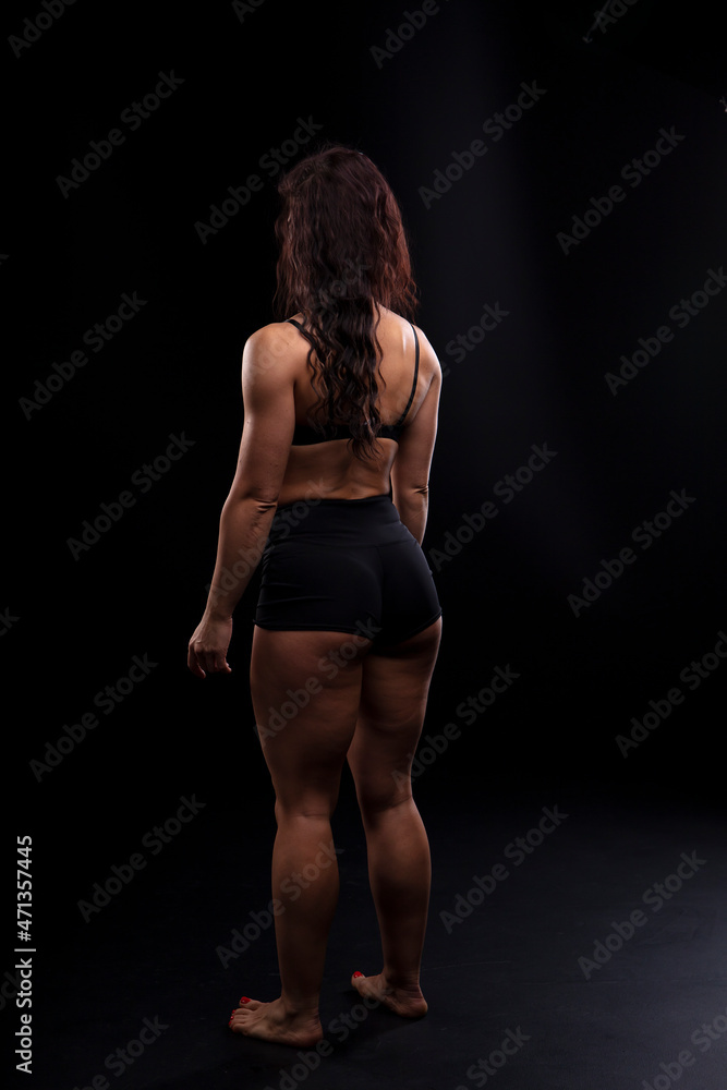 Portrait of beautiful athletic woman with long curly black hair. Bodybuilding Portrait of beautiful athletic woman with long curly black hair. Bodybuilding