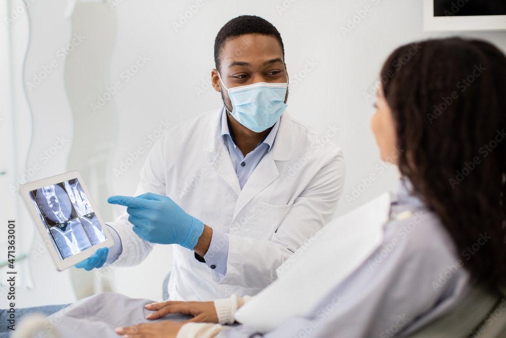 Black Stomatologist Showing Digital Tablet With Teeth Xray Picture To Female Patient Black Stomatologist Showing Digital Tablet With Teeth Xray Picture To Female Patient