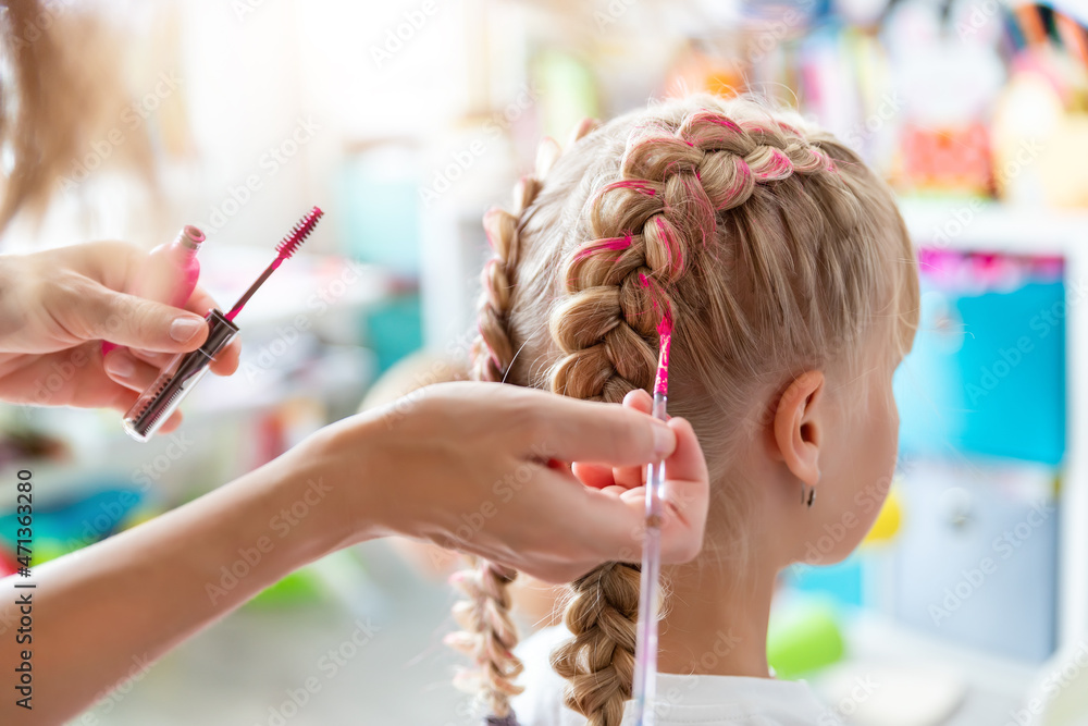 Close-up mother hand holding brush make dyed braids with pink color on  little daughter kid head. Hairdresser stylist applying glitter paint  braiding hair on young girl. Get ready party celebration Stock Photo |