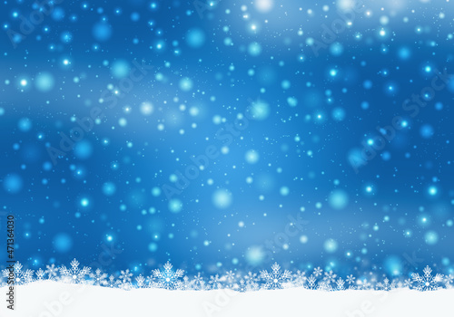 Winter holidays background with snow on the ground and heavy snow. Blue Christmas card design.
