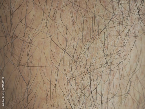 Man with a lot of black hair of the leg. closeup photo  blurred.