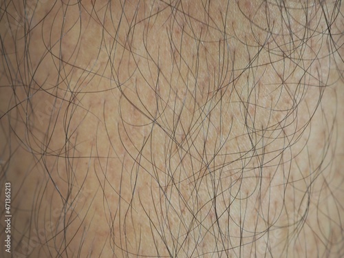 Man with a lot of black hair of the leg. closeup photo, blurred.