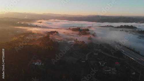 sunrise rays through mist over the city