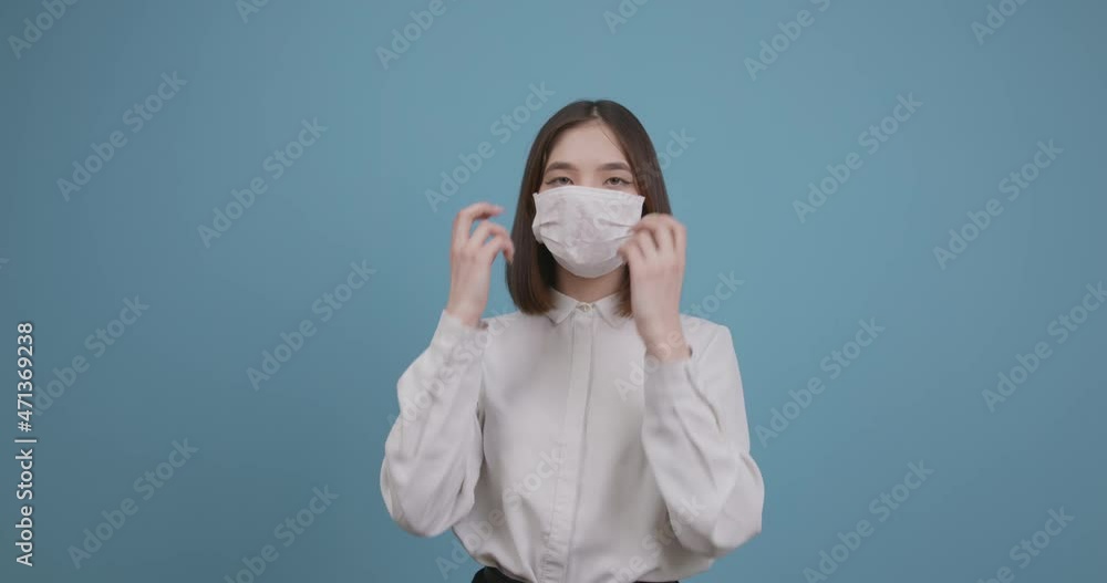 Coronovirus, covid-19. Cute teenage girl of Asian appearance in a medical mask on an isolated background Coronovirus, covid-19. Cute teenage girl of Asian appearance in a medical mask on an isolated background
