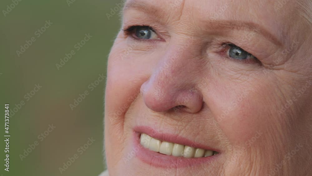 Head shot closeup portrait of pleasant smiling mature woman. Happy healthy middle aged lady relaxing alone, looking aside, having wide smile white straight teeth. Positive satisfied retirement concept Head shot closeup portrait of pleasant smiling mature woman. Happy healthy middle aged lady relaxing alone, looking aside, having wide smile white straight teeth. Positive satisfied retirement concept